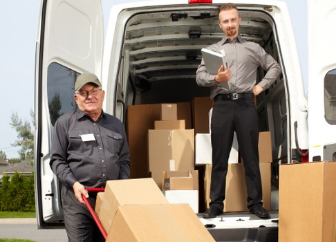 Furniture removals team handling household items in Acton