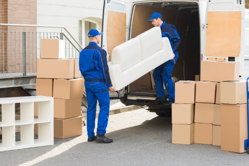 Man and van team handling boxes and furniture in West London