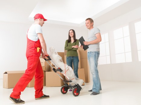 Packed boxes and small furniture ready for student removals in Acton