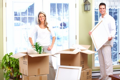 Careful handling of office equipment during a move in West London