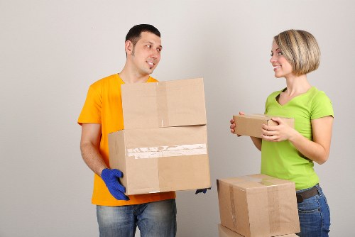 Professional movers loading boxes and furniture for an Acton house move