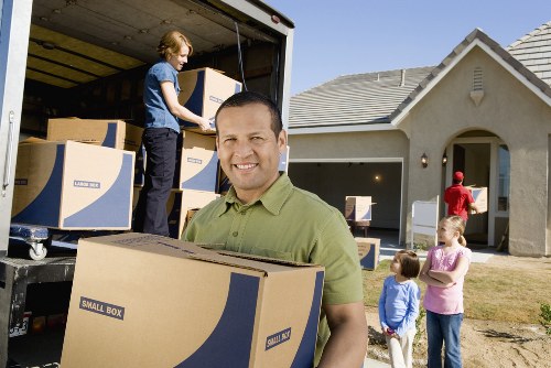 Professional house moving team assisting a family move in Acton